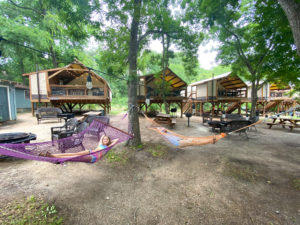 Father and Daughter Lounging on Geronimo Creek Treehouses Hammocks
