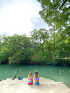 Girls sitting in front of Geronimo Creek Seguin Texas