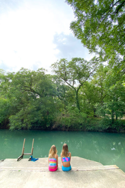 Girls sitting in front of Geronimo Creek Seguin Texas