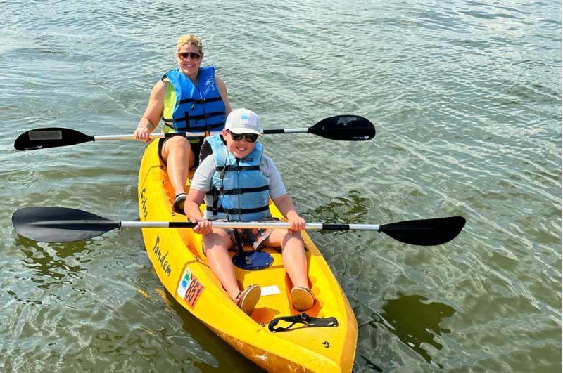 Conroe Is A Family Destination - two people on the lake in a yellow kayak